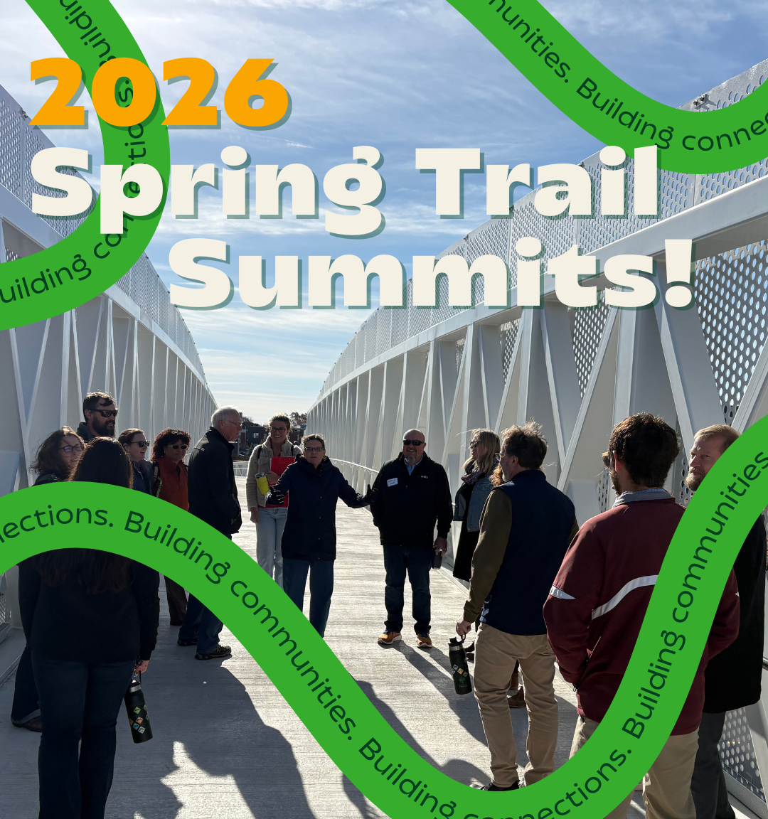 Group of people at the 2026 Spring Trail Summits on a bridge, promoting West Michigan Trails and community connections.