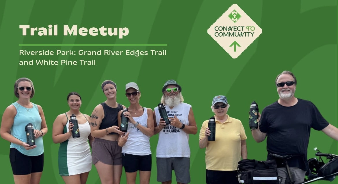Group enjoying Trail Meetup at Riverside Park with water bottles, ready for Grand River Edges and White Pine Trail.